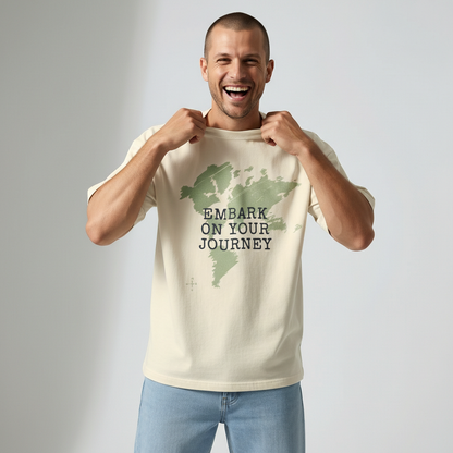 Man smiling and playfully adjusting the collar of a cream outdoor lifestyle graphic t-shirt.