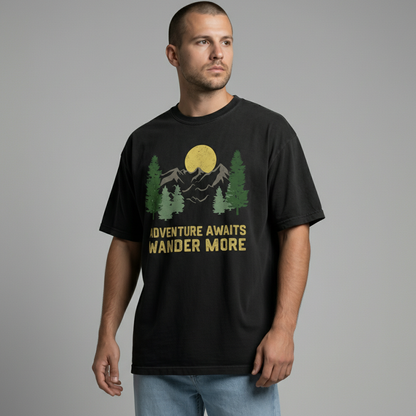 Front view of a man looking slightly down, wearing a black relaxed-fit nature graphic t-shirt.