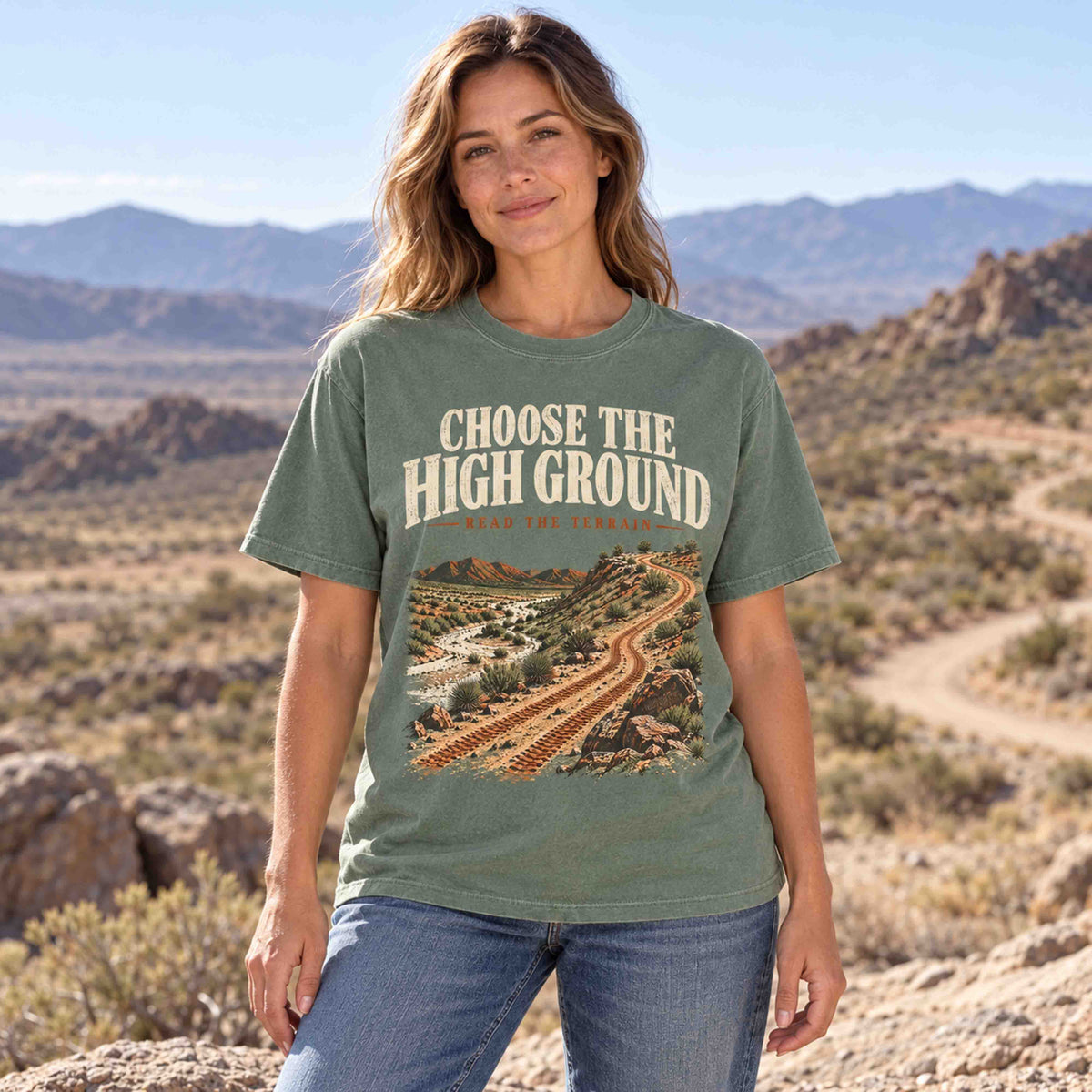 Woman wearing the Moss Choose the High Ground off-road graphic tee at a desert overlook.