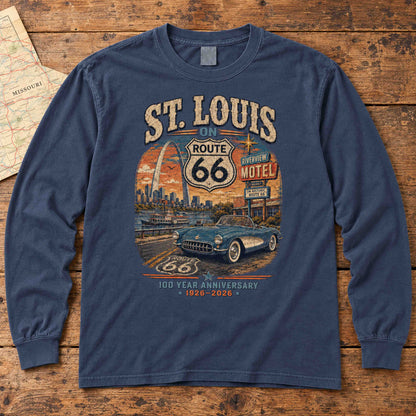 Navy St. Louis Missouri Route 66 long sleeve tee laid flat on wood, showing Gateway Arch, convertible and centennial artwork.
