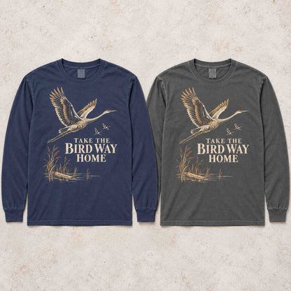 Navy and Pepper sandhill crane long sleeve shirts laid flat side by side.