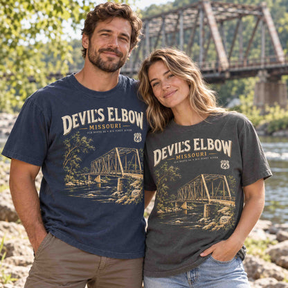 Man and woman wearing Being is Good Devil's Elbow Missouri Route 66 T-shirts in Navy and Pepper beside a river and steel truss bridge.