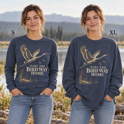 Same model showing the Navy sandhill crane long sleeve shirt in sizes S and XL.