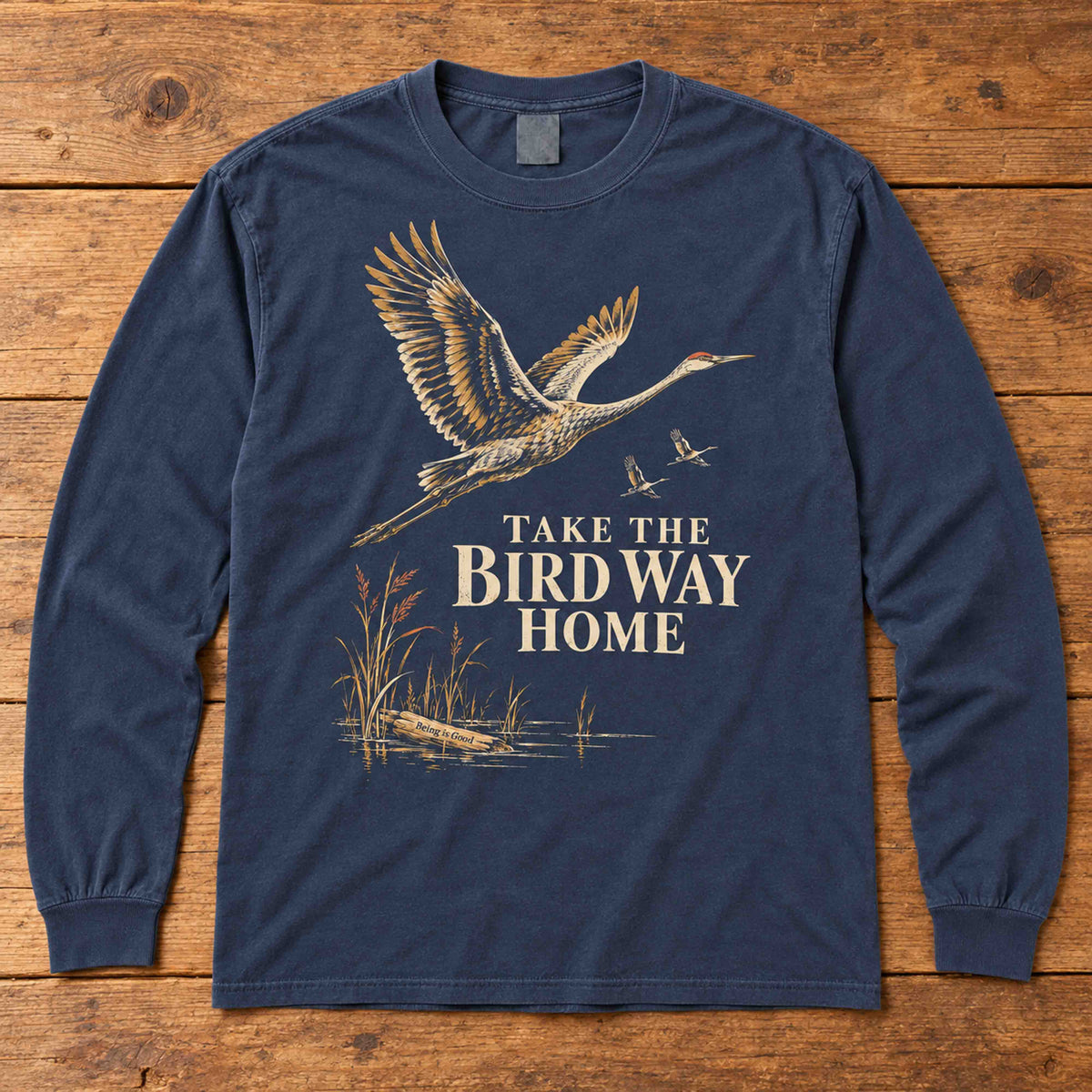 Navy sandhill crane long sleeve shirt laid flat, showing the Take the Bird Way Home graphic.