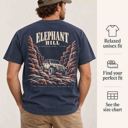 Close-up of the Elephant Hill Canyonlands back print on a Navy tee, with relaxed-fit and size-chart guidance.