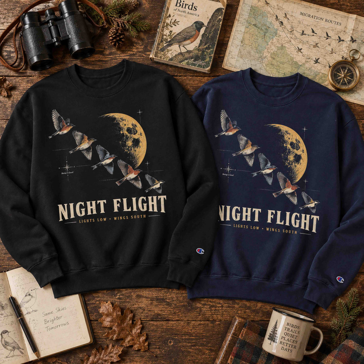 Night Flight Bird Migration Champion graphic sweatshirt flat lay with moon and migrating bird artwork
