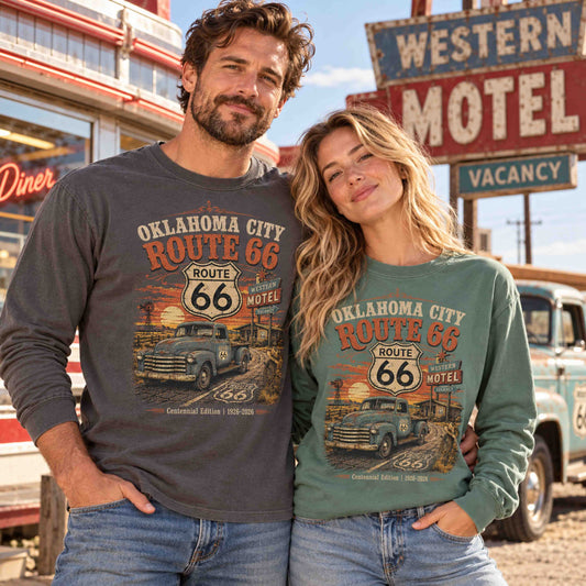 Man in Pepper and woman in Light Green wearing Oklahoma City Route 66 long sleeve tees with vintage pickup truck and sunset graphics.