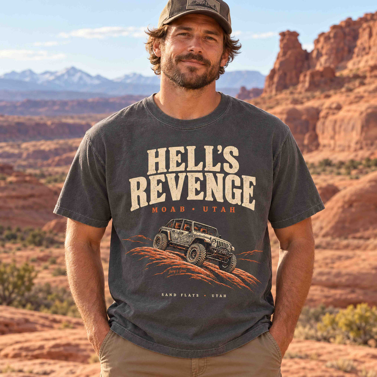 Man wearing a Pepper Hell’s Revenge Moab off-road graphic t-shirt in a desert landscape.