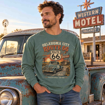 Man wearing a Light Green Oklahoma City Route 66 long sleeve tee beside a weathered pickup truck and motel sign.