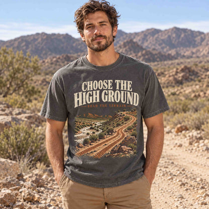 Man wearing the Pepper Choose the High Ground off-road graphic tee on a rocky desert trail.