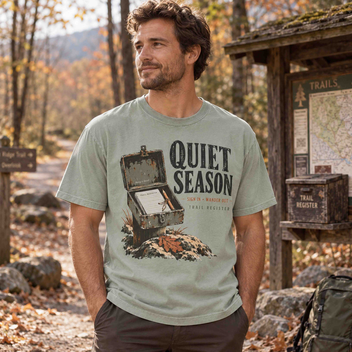 Quiet Season Trail Register graphic tee worn at a forest trailhead in autumn