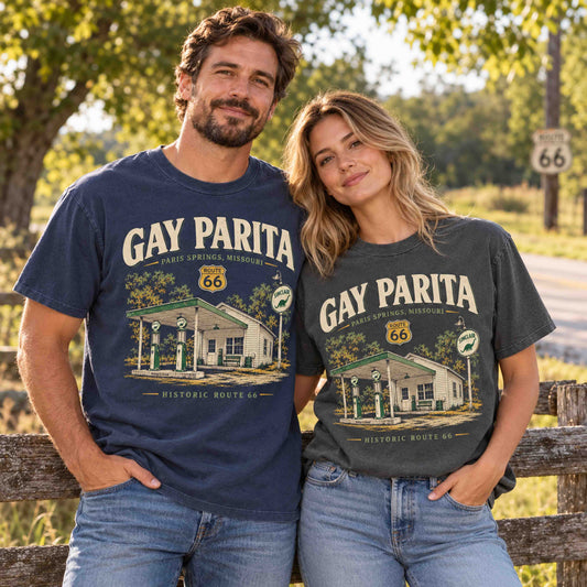 Man and woman wearing Being is Good Gay Parita Paris Springs Route 66 graphic T-shirts in Navy and Pepper outdoors.