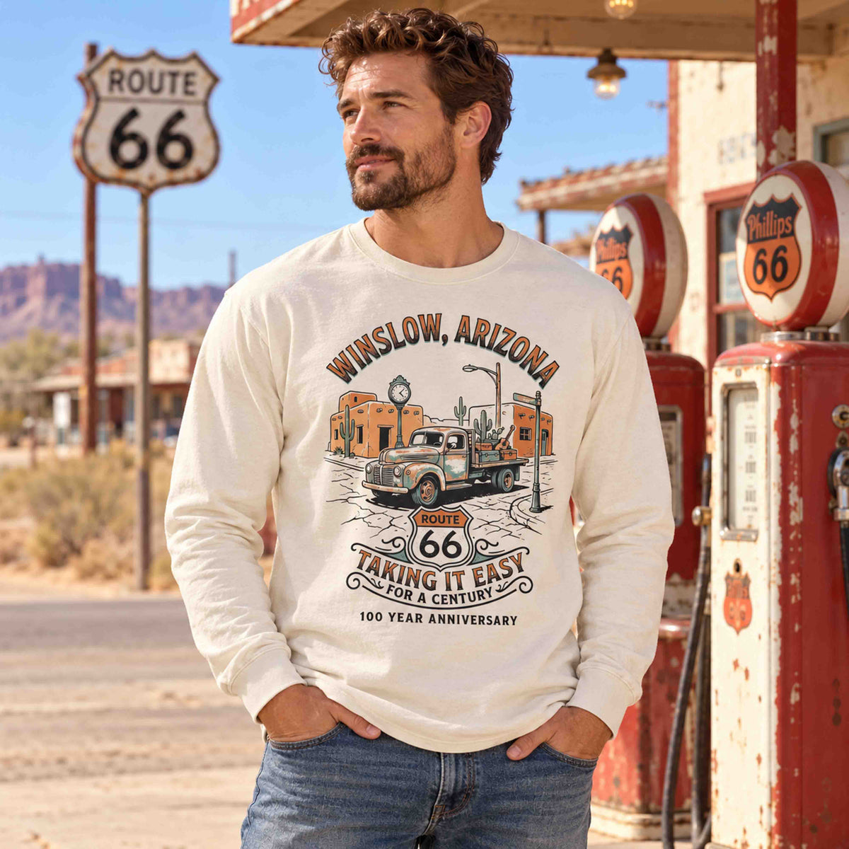 Man wearing an Ivory Winslow Arizona Route 66 long sleeve tee beside vintage gas pumps.