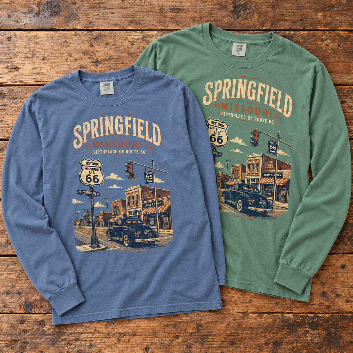 Blue Jean and Light Green Springfield Missouri Route 66 long sleeve graphic tees arranged flat on a wooden table.