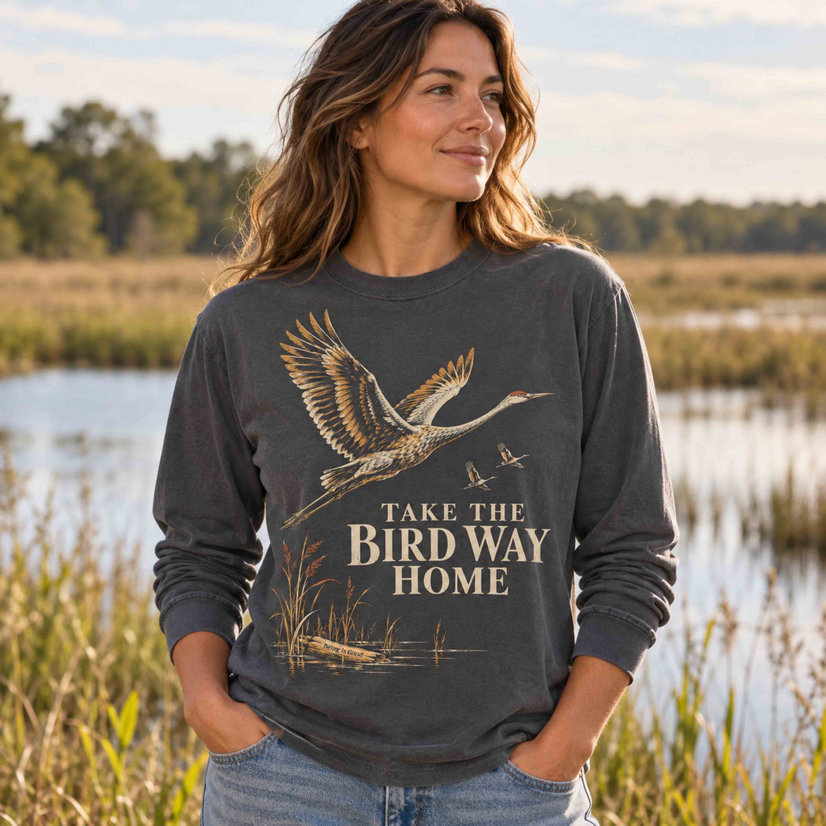 Woman wearing the Pepper Take the Bird Way Home long sleeve shirt near a wetland.