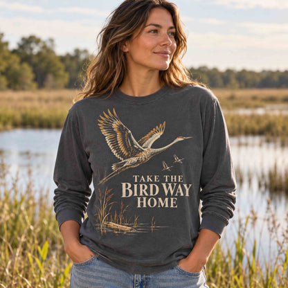Woman wearing the Pepper Take the Bird Way Home long sleeve shirt near a wetland.
