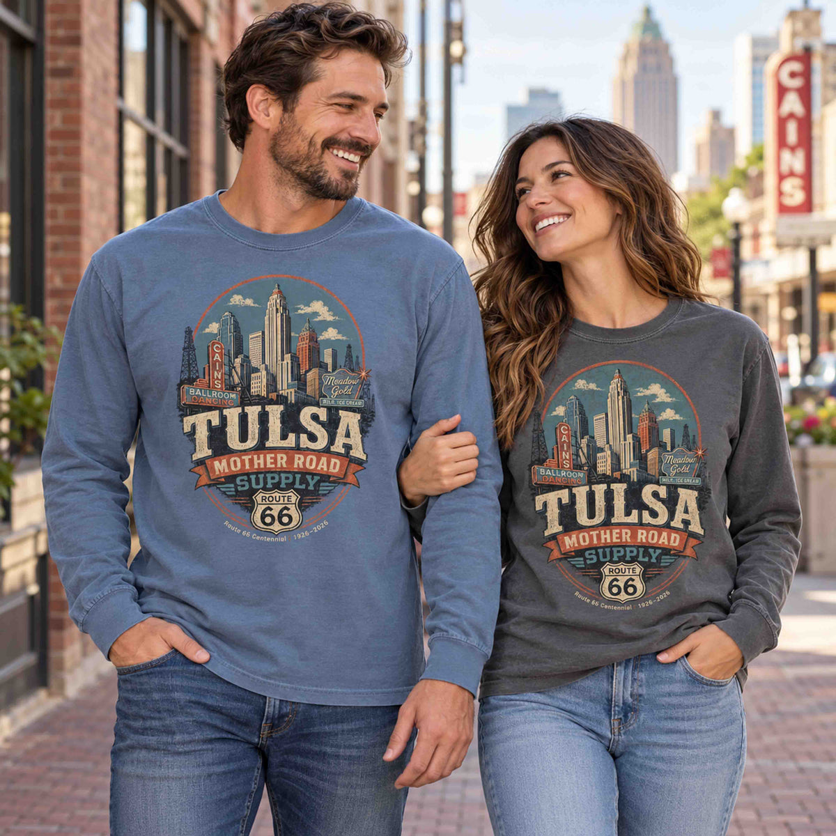 Man in Blue Jean and woman in Pepper wearing Tulsa Oklahoma Route 66 long sleeve tees with skyline and Mother Road Supply graphics.