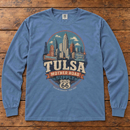 Blue Jean Tulsa Oklahoma Route 66 long sleeve tee laid flat on wood, showing skyline, vintage signs and Mother Road Supply artwork.
