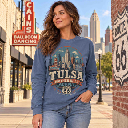 Woman wearing a Blue Jean Tulsa Route 66 long sleeve graphic tee beside a highway shield mural.