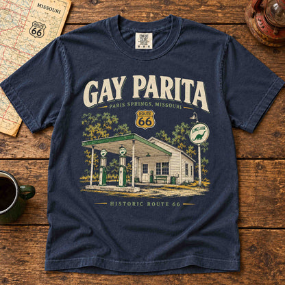 Navy Gay Parita Paris Springs Route 66 T-shirt laid flat on wood, showing vintage gas station artwork.