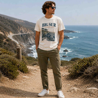 Men's Big Sur California Coast graphic tee styled with olive pants on a coastal trail