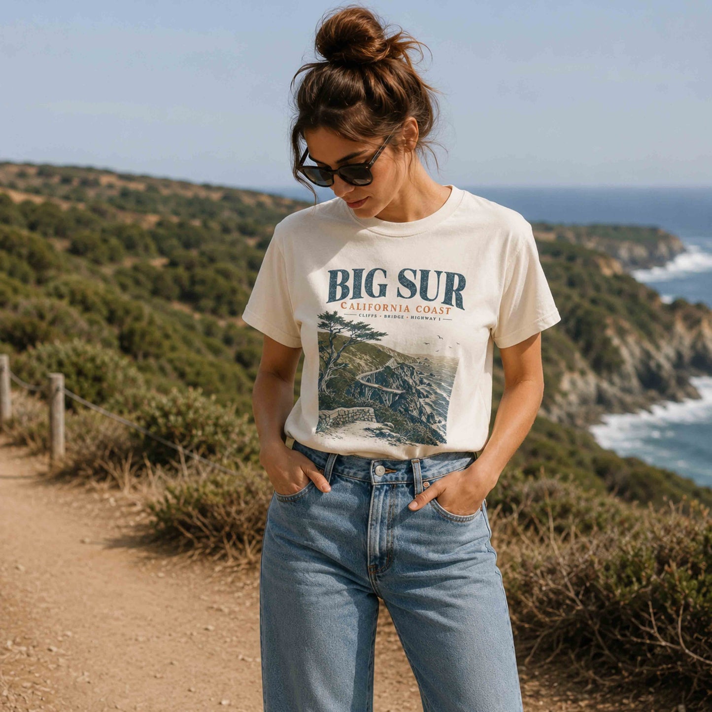 Women's Big Sur California Coast graphic tee styled with jeans on a coastal trail