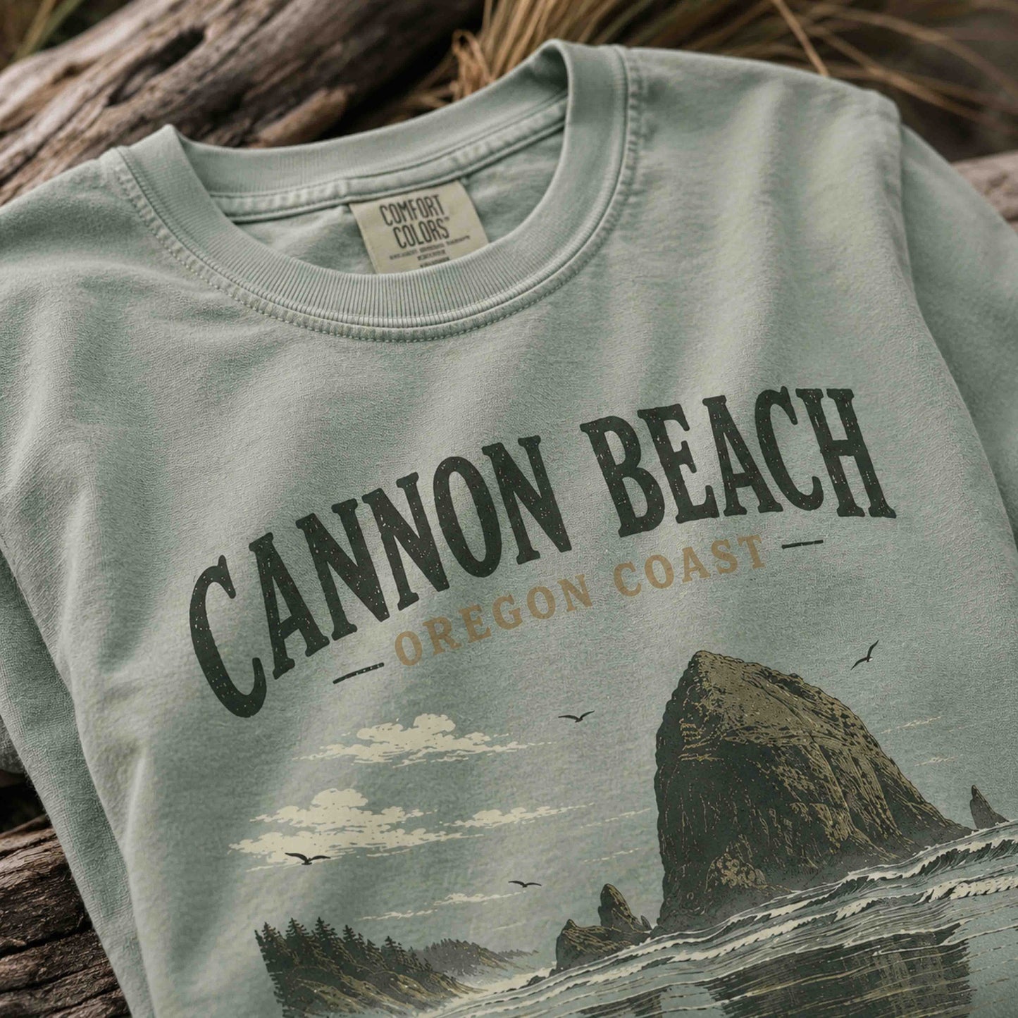 Close-up of Cannon Beach Oregon Coast graphic print on a Bay t-shirt