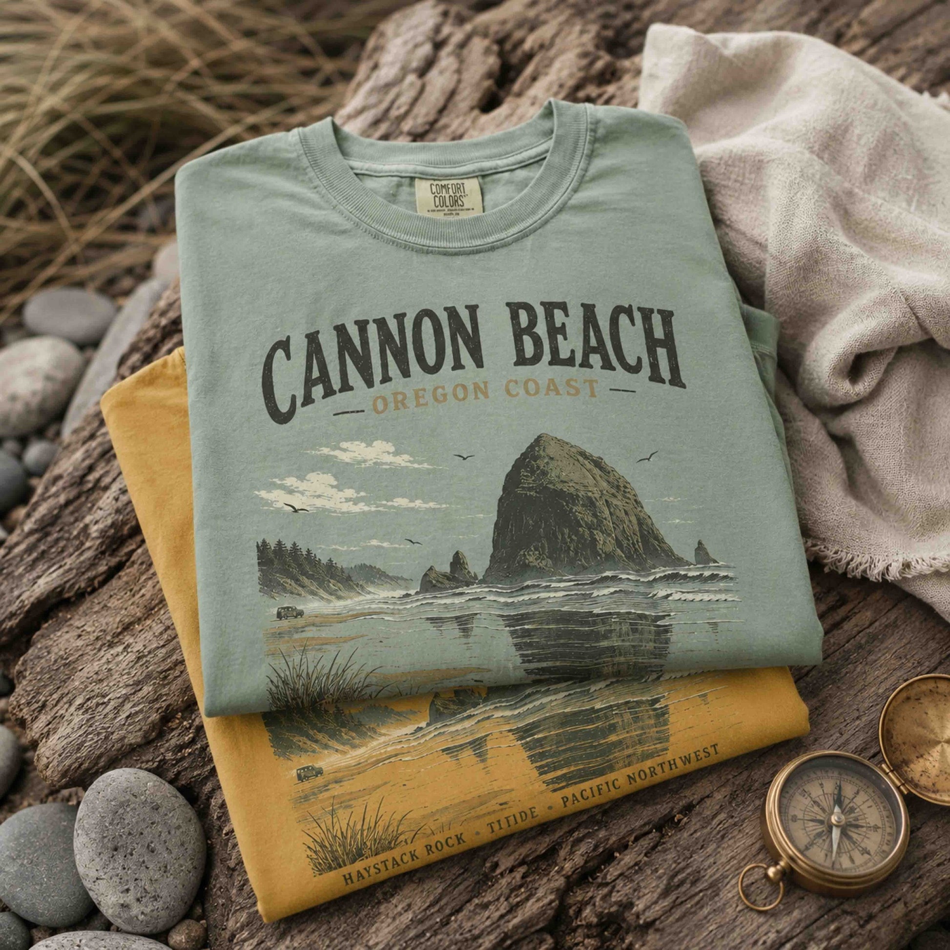 Folded Cannon Beach Oregon Coast graphic t-shirts in Bay and Mustard