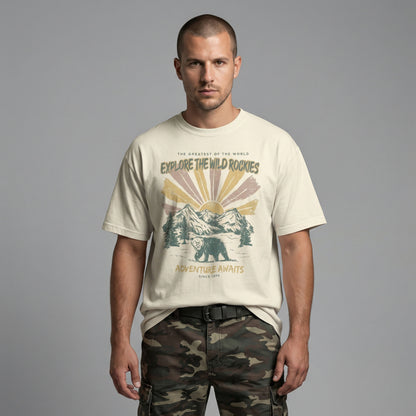 Straight-on view of a man modeling a cream everyday-fit t-shirt with a retro mountain and bear illustration.
