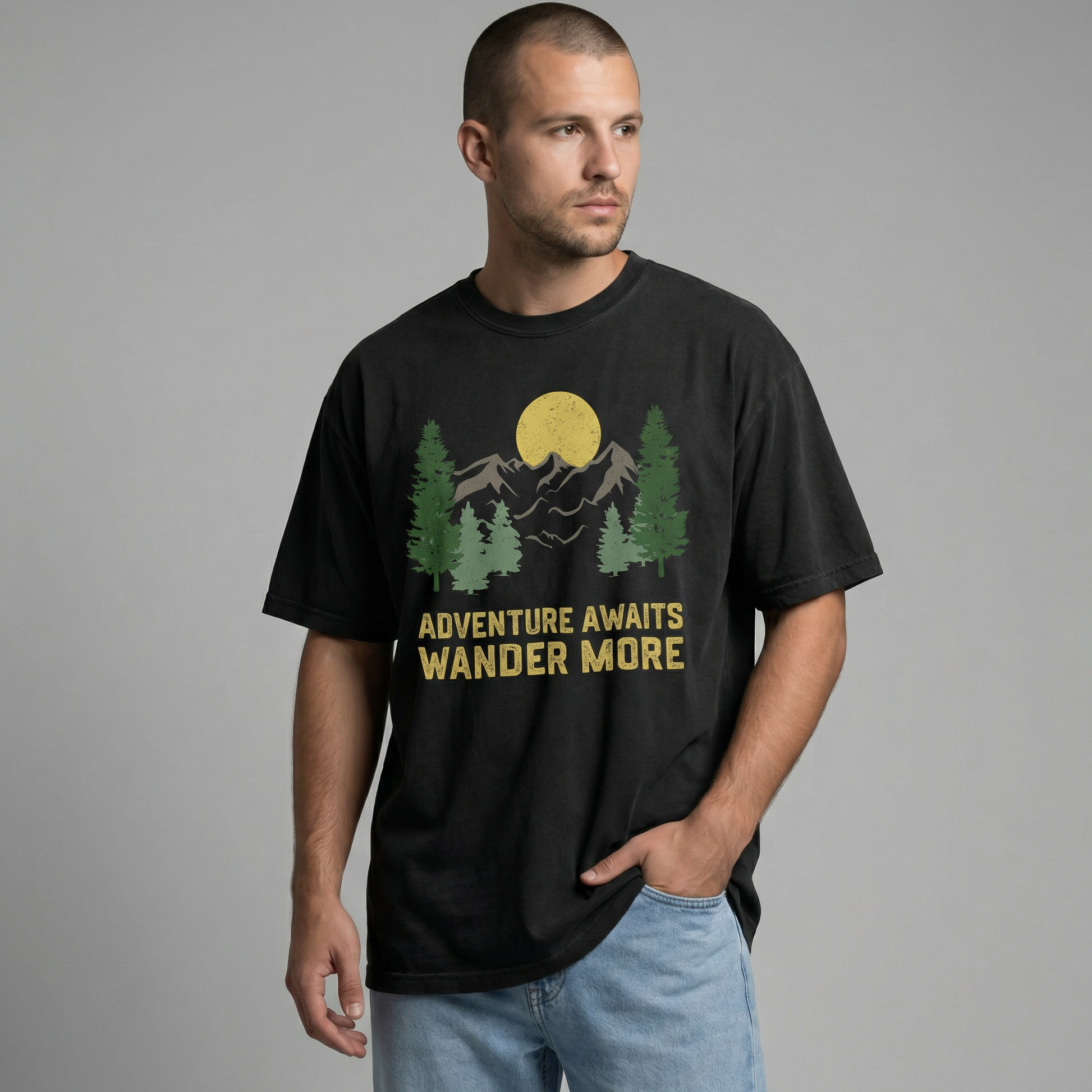 Man looking off-camera wearing a relaxed-fit black t-shirt with a vintage mountain and forest graphic reading "Adventure Awaits Wander More".