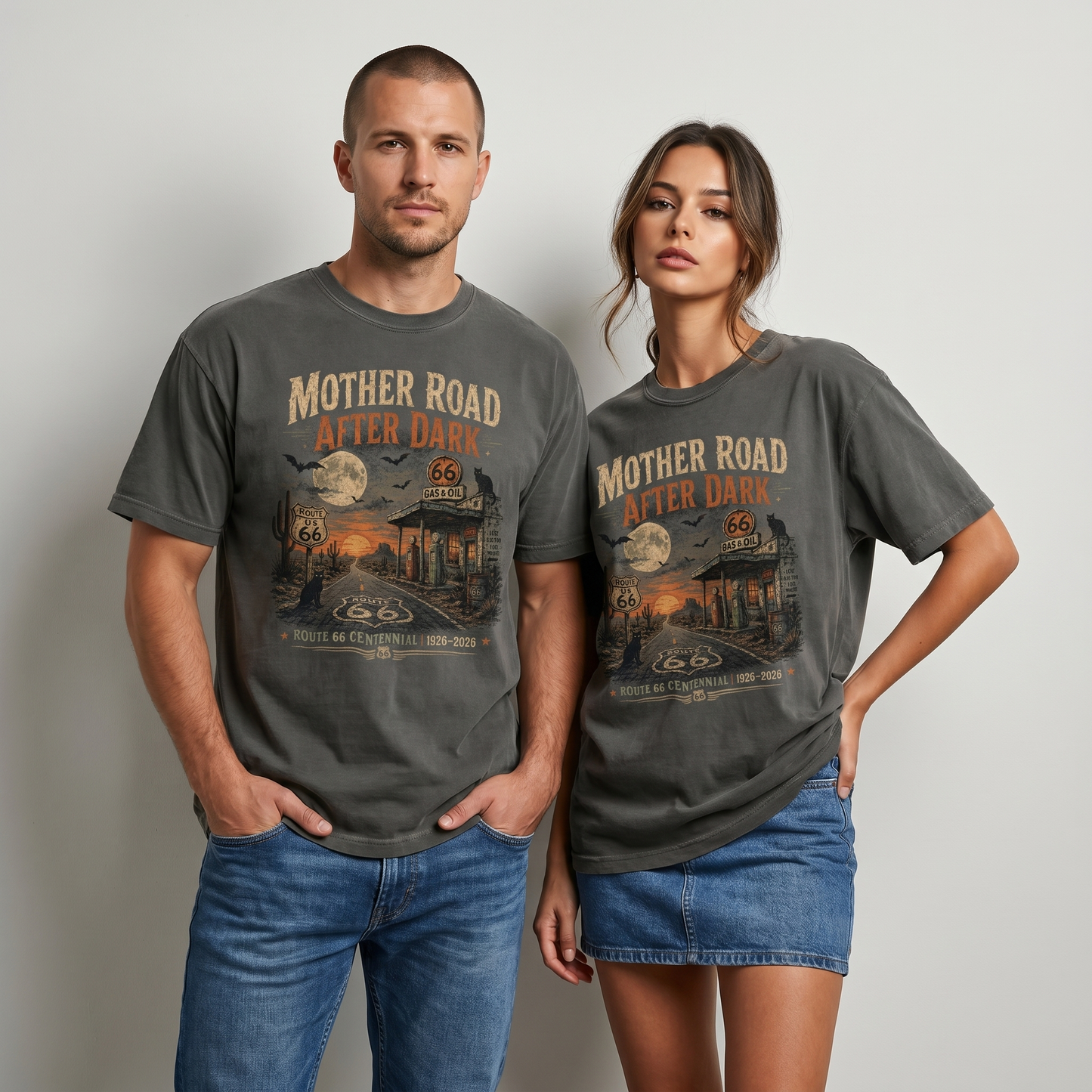 Unisex Route 66 Halloween graphic tee featuring Mother Road After Dark artwork with moon, bats, desert road, gas station, cactus, black cat, and 1926–2026 centennial text.