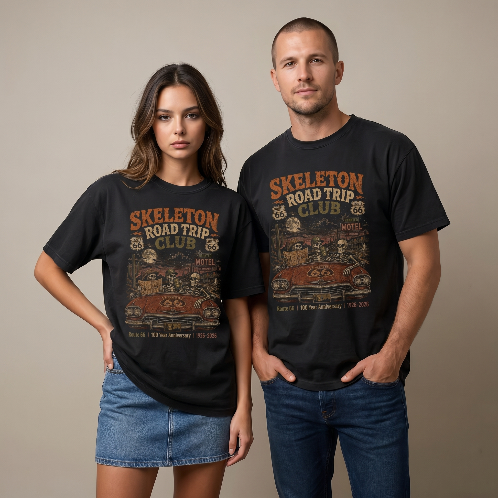 Unisex black Route 66 graphic tee featuring Skeleton Road Trip Club artwork with skeletons in a vintage car, haunted motel, desert cactus, moon, and 1926–2026 anniversary text.
