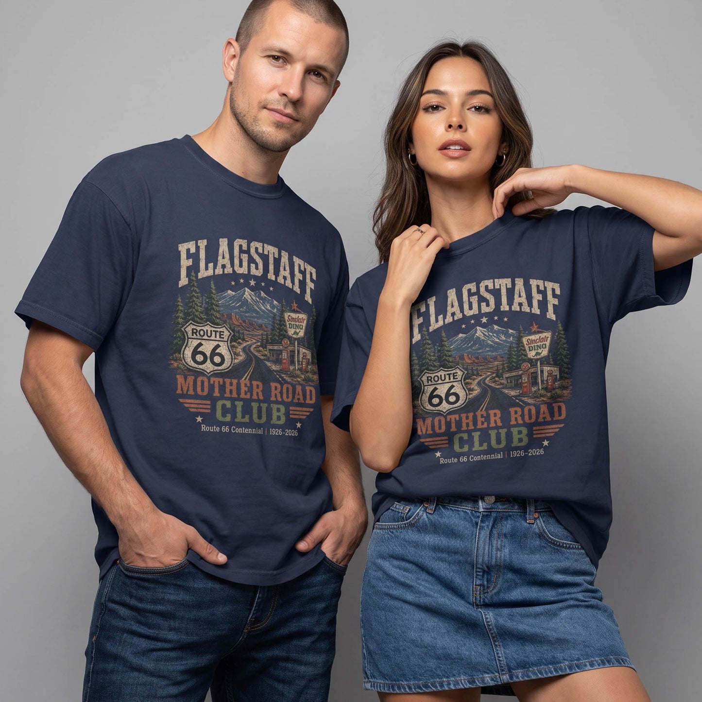 Unisex Flagstaff Route 66 graphic tee featuring mountain scenery, pine trees, Route 66 shield, roadside diner artwork, and 1926–2026 centennial text.