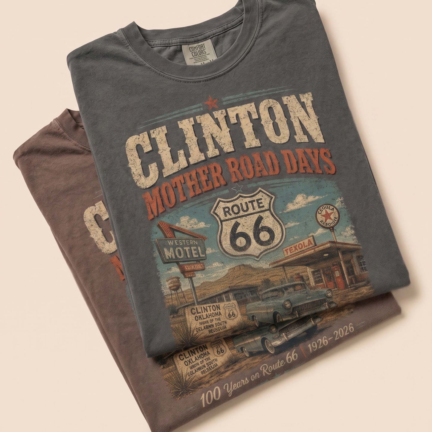 Unisex Clinton Oklahoma Route 66 graphic tee featuring Mother Road Days text, motel signage, Route 66 shield, classic car artwork, and 1926–2026 anniversary details.