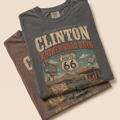 Unisex Clinton Oklahoma Route 66 graphic tee featuring Mother Road Days text, motel signage, Route 66 shield, classic car artwork, and 1926–2026 anniversary details.