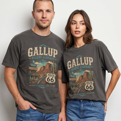 Unisex Gallup New Mexico Route 66 graphic tee featuring desert highway artwork, motel sign, canyon scenery, cactus details, Route 66 shield, and vintage Southwest travel style.
