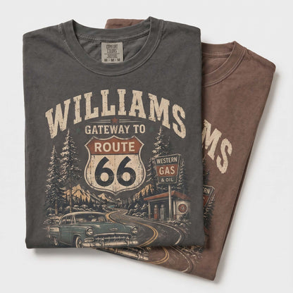 Unisex Williams Arizona Route 66 graphic tee featuring Gateway to Route 66 text, pine trees, mountain road scenery, vintage gas station, classic car, and 1926–2026 centennial details.