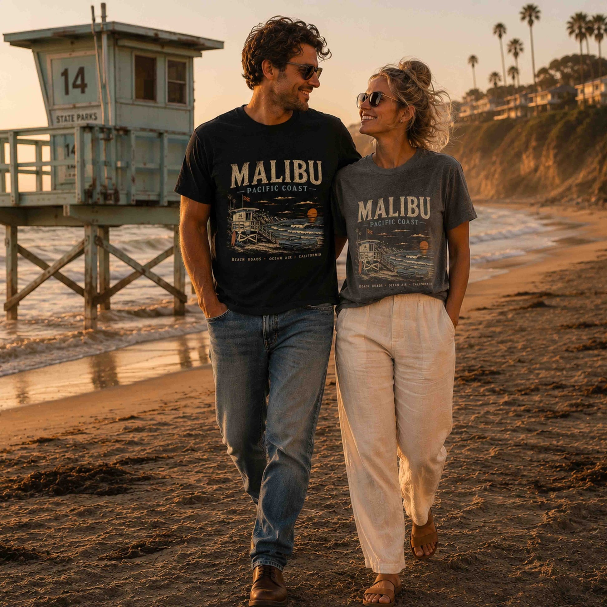 Malibu Pacific Coast graphic t-shirt in Black and Pepper on a couple at the beach
