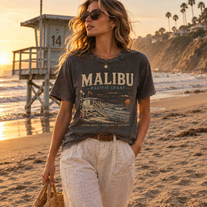 Women's Malibu Pacific Coast graphic t-shirt in Pepper at sunset on the beach
