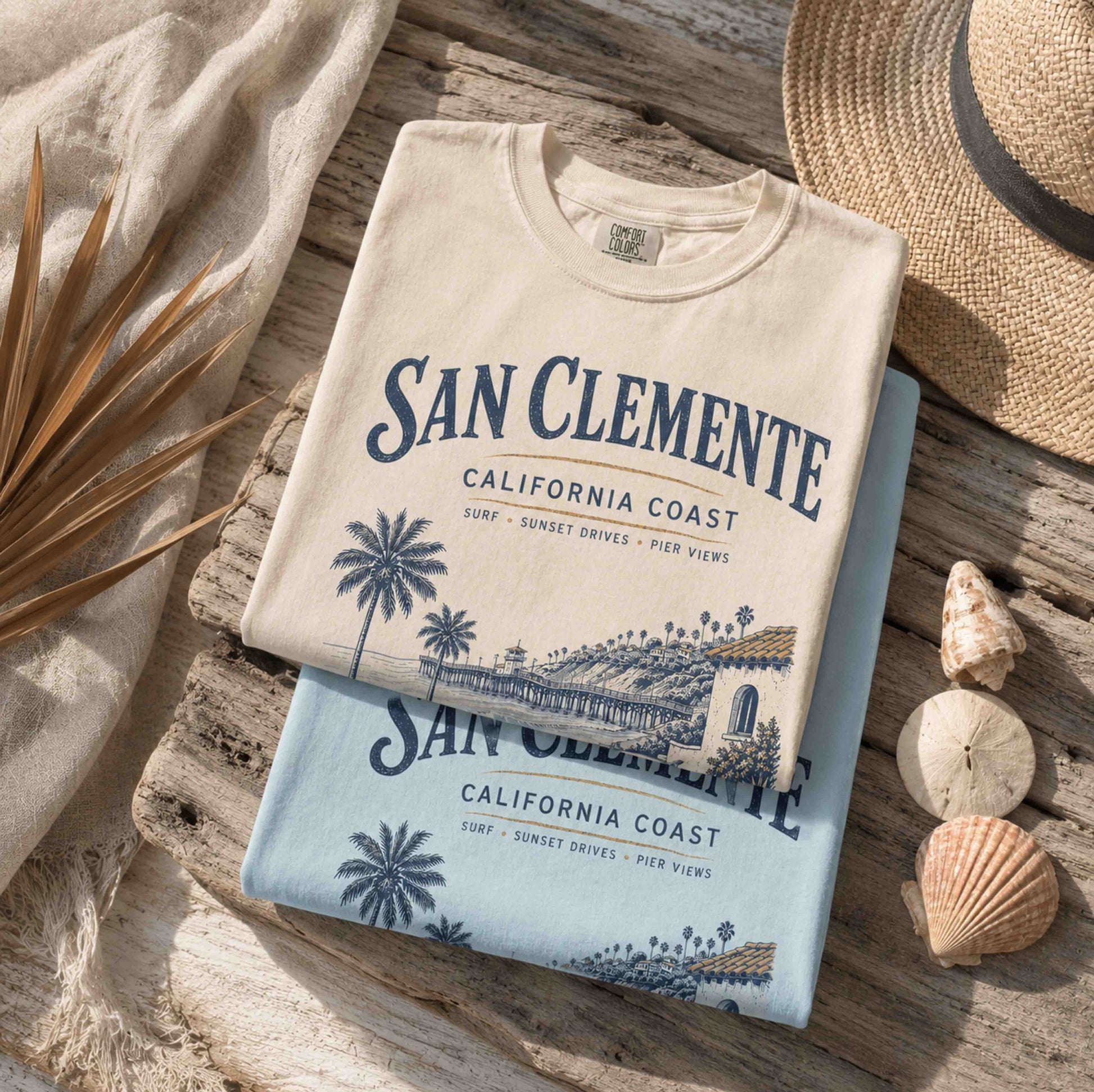 Folded San Clemente California Coast graphic t-shirts in Ivory and Chambray