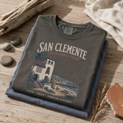 Folded San Clemente California Coast graphic t-shirts in Pepper and Blue Jean