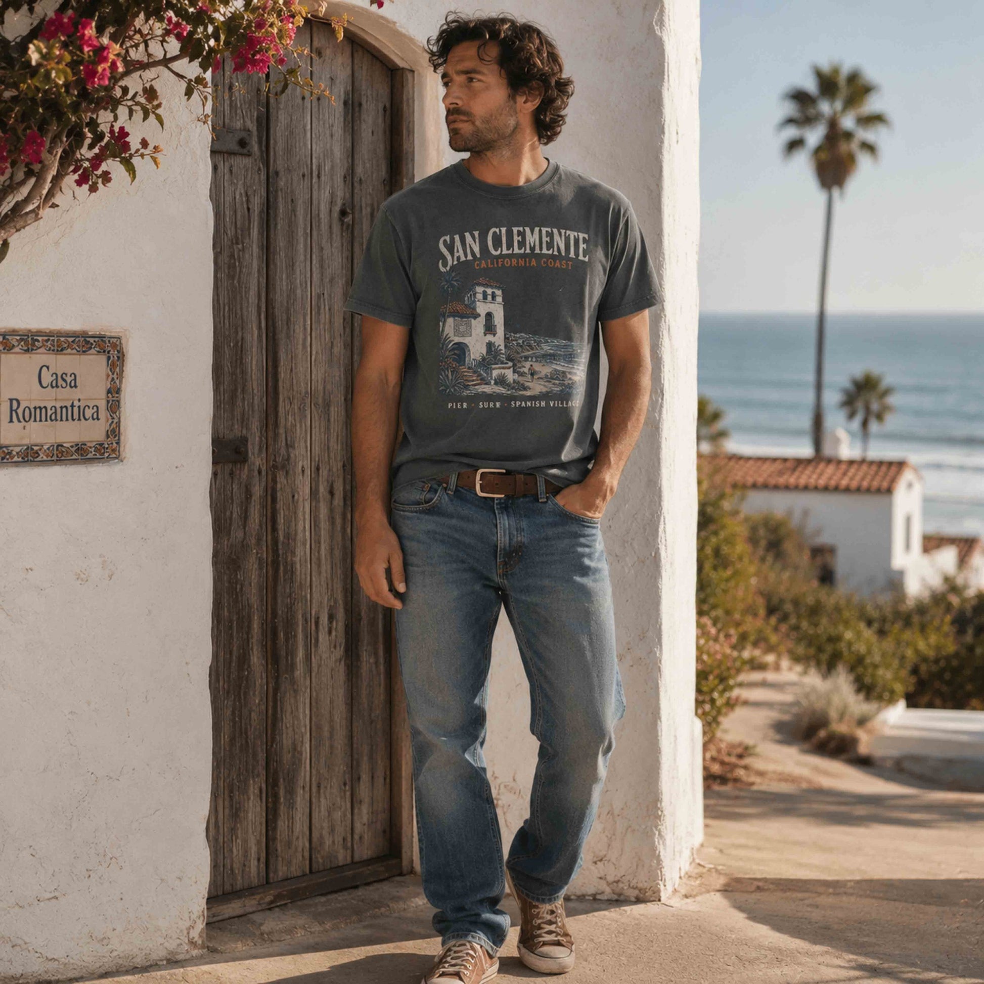 San Clemente California Coast graphic t-shirt in Pepper on a man near Casa Romantica and the Pacific Ocean